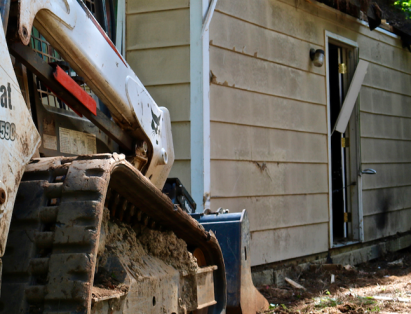 Bobcat prepares for demolition to an old, unused shed