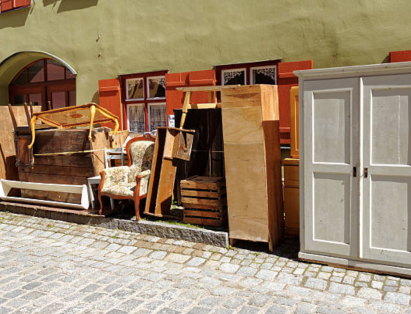 Junk Furniture Stacked In Street ready to be removed by Altitude Hauling