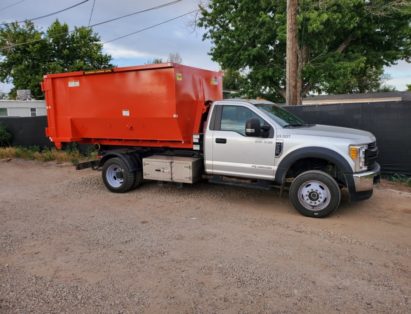 A dumpster being delivered by Altitude Hauling